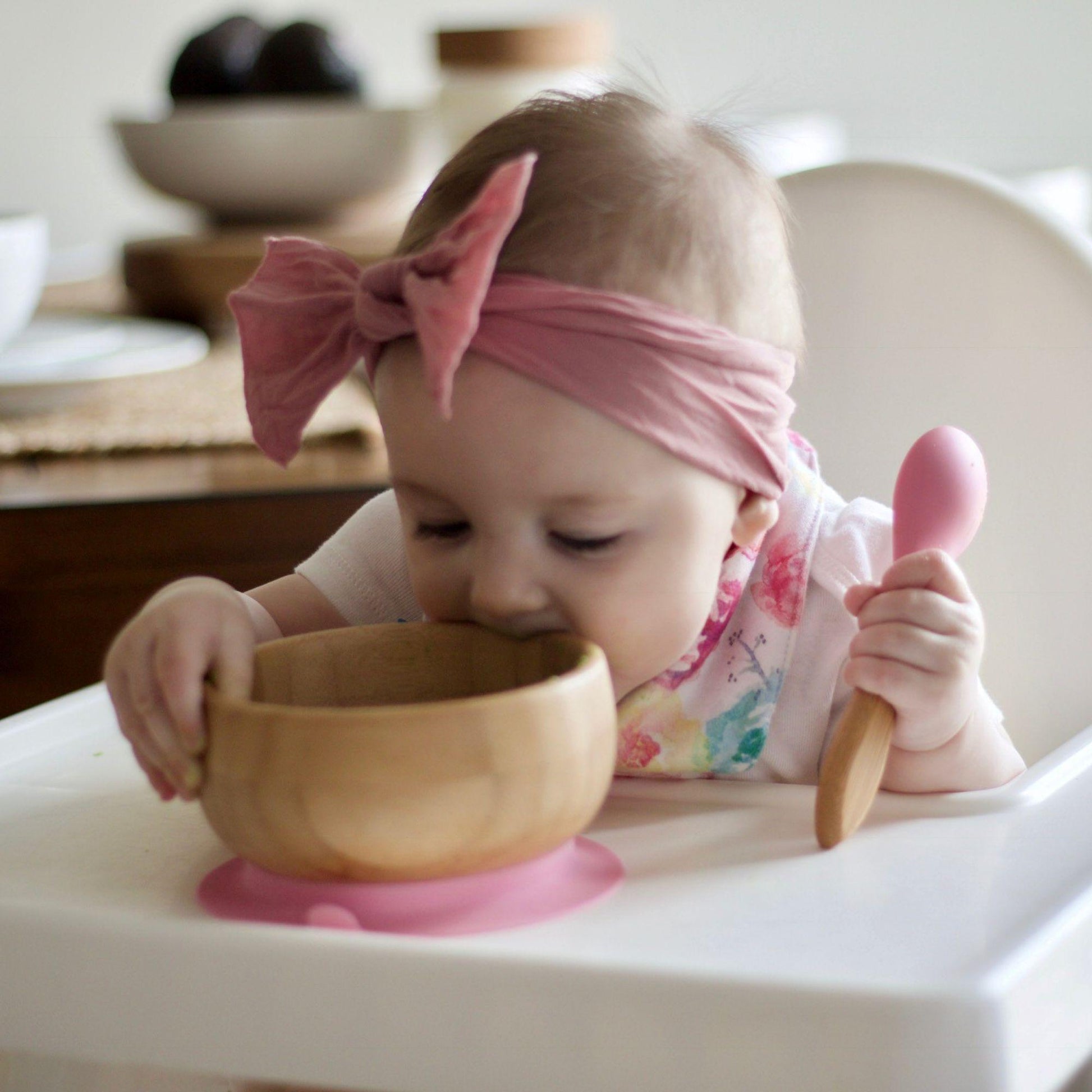 baby girl eating with Avanchy - Organic Bamboo Suction Bowl & Spoon Set - Pink